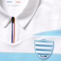 Détail du blason brodé ciel et bleu du maillot de légende du Club de rugby Racing 92.